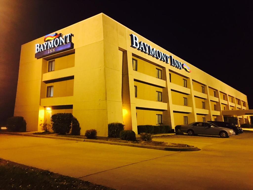 a large building with a sign on top of it at Baymont by Wyndham Paducah in Paducah