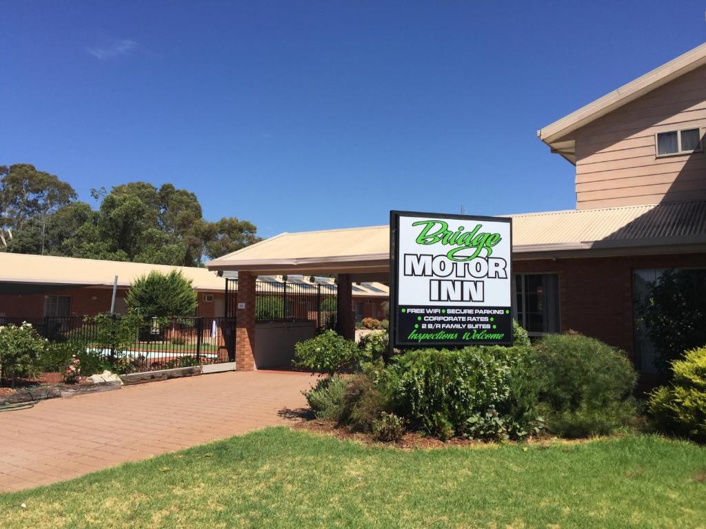 a sign for a motor inn in front of a house at Bridge Motor Inn Tocumwal in Tocumwal