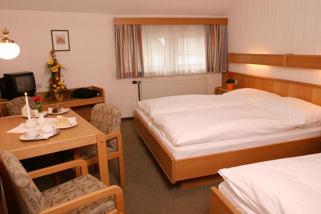 una camera d'albergo con 2 letti, una scrivania e un tavolo di Gasthof Erzherzog Franz Ferdinand a Markt Sankt Florian