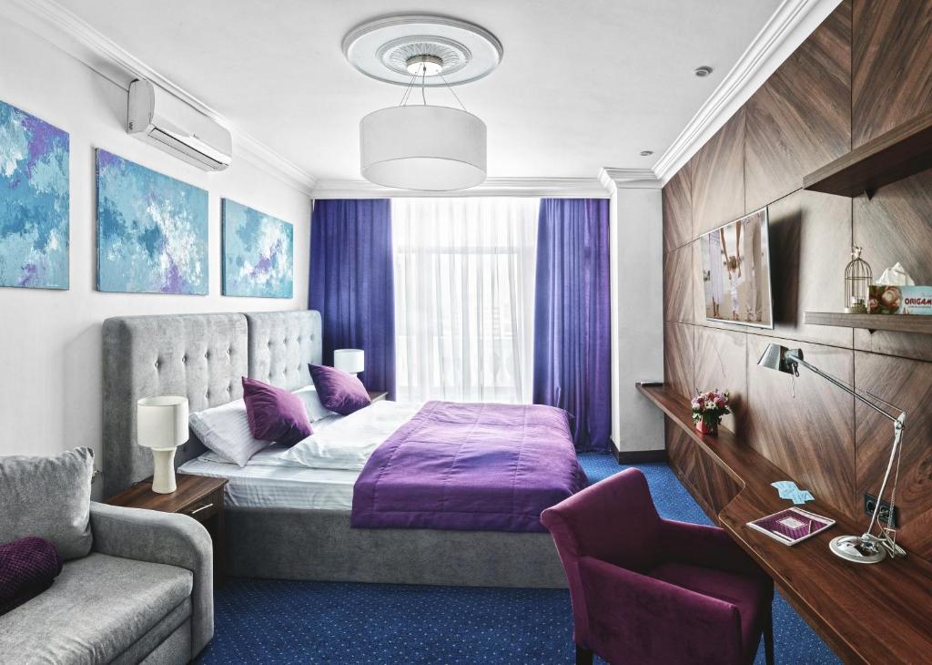 a hotel room with a bed and a couch at Hotel Fridman in Odesa