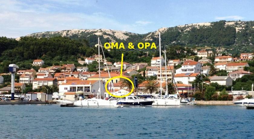 a group of boats are docked in a harbor at Apartaments Oma & Opa in Rab
