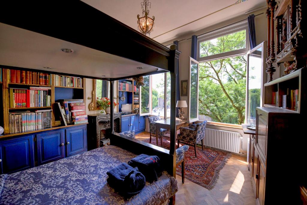 a living room with a large bed and a window at CubaCasa in Den Bosch