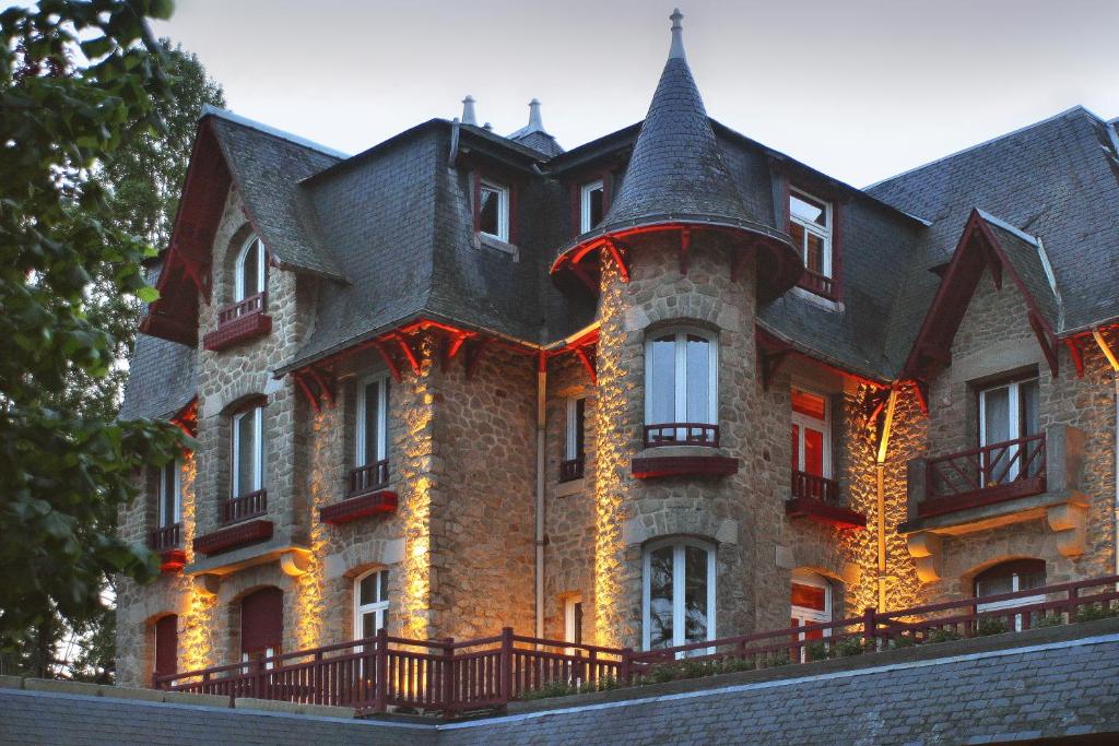 a large brick building with a large roof at Le Castel Marie Louise in La Baule