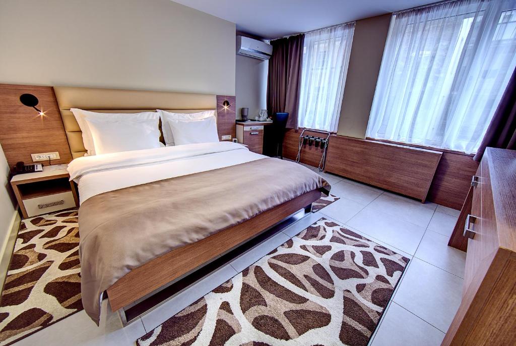 a bedroom with a large bed in a room at Hotel Srbija Garden-FREE PARKING in Belgrade