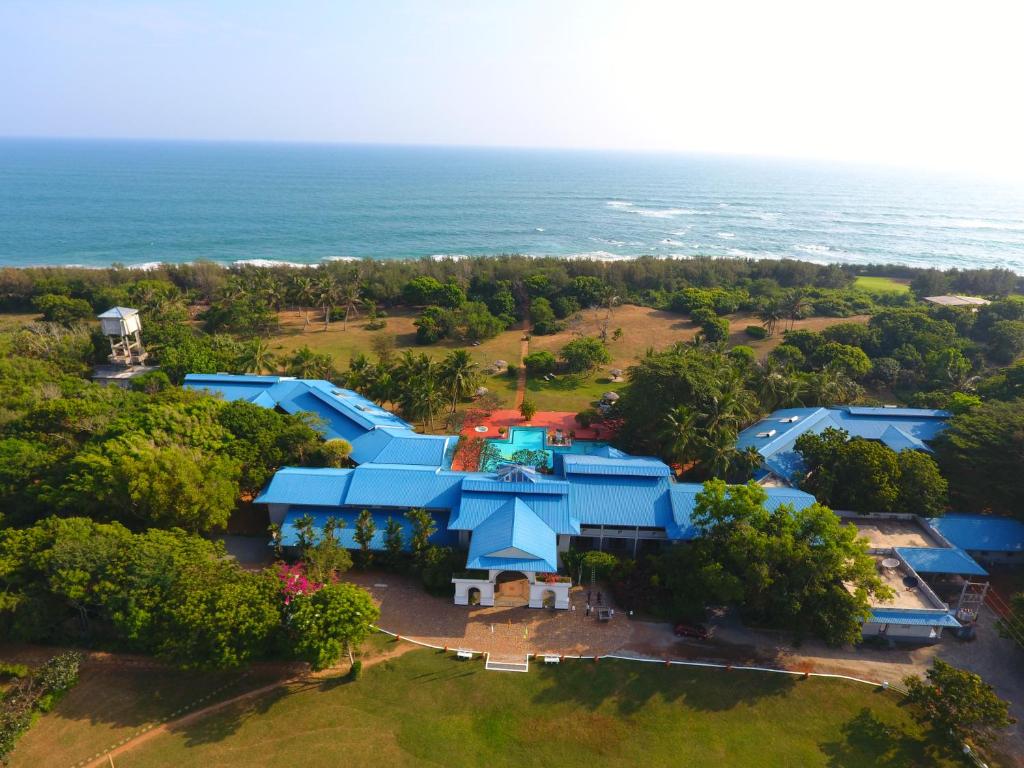 an overhead view of a large blue building next to the ocean at The Oasis Beach Resort in Hambantota