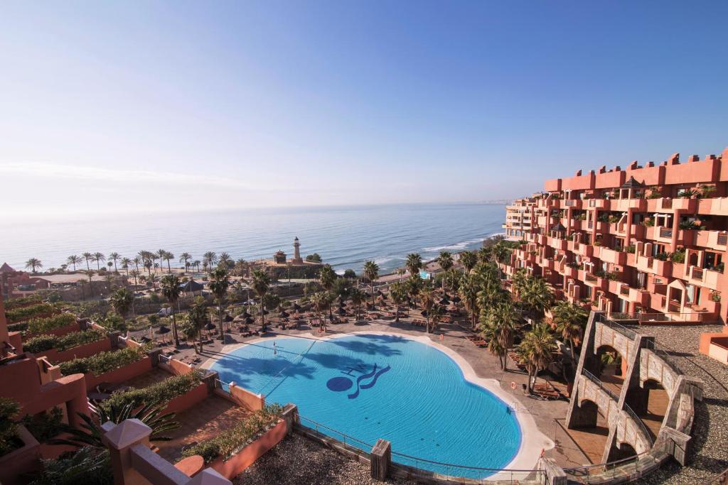 
a beach scene with a balcony overlooking the ocean at Holiday World Polynesia in Benalmádena
