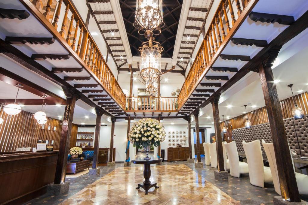 a large lobby with a table with flowers on it at Felicia Hotel & Suites in Cuenca