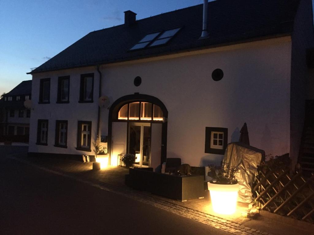 a white house with lights in front of it at Altes Pfarrhaus Hunolstein in Hunolstein