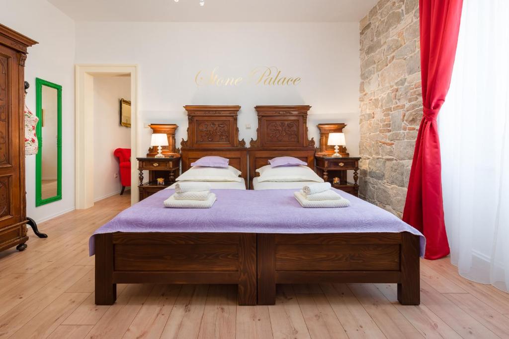 a bedroom with a large bed with a purple mattress at Luxury Boutique Apartment Stone Palace in Split