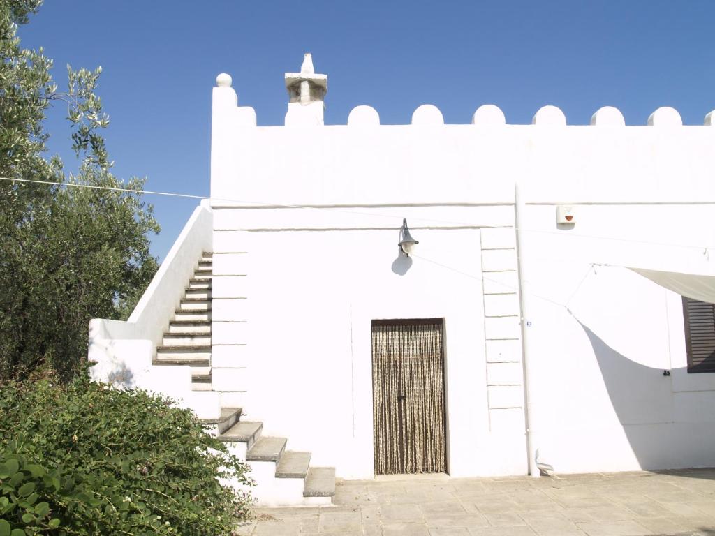 a white church with stairs and a door at Case d'Artista in Savelletri di Fasano