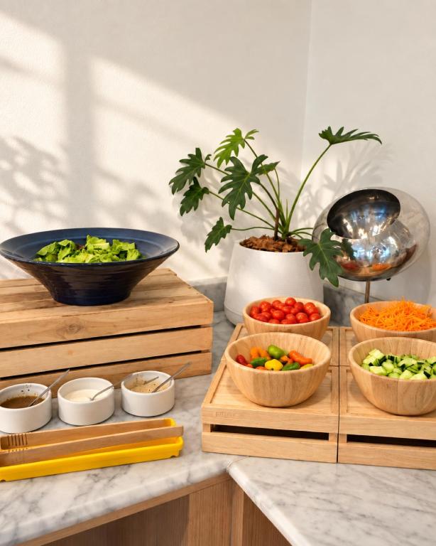 A brightly lit breakfast counter with vegetables, sauces, and toppings.