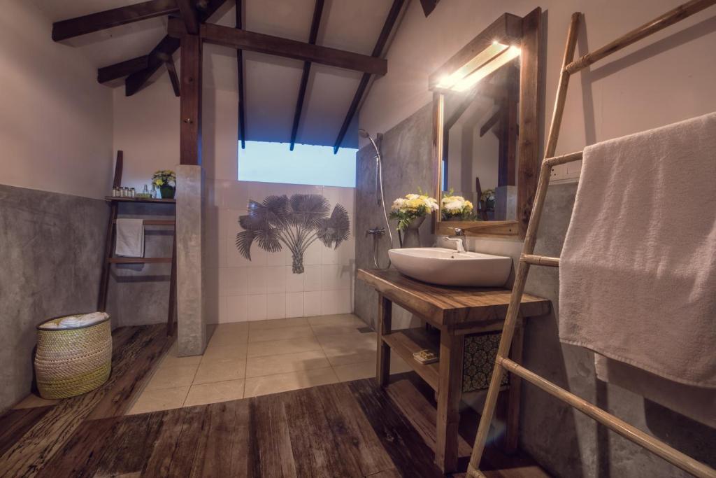 a bathroom with a sink and a mirror at C Beyond Nilaveli in Nilaveli