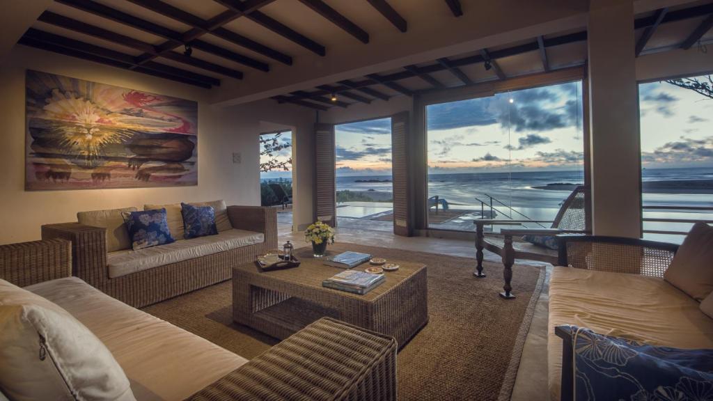 a living room with a view of the ocean at C Beyond Nilaveli in Nilaveli