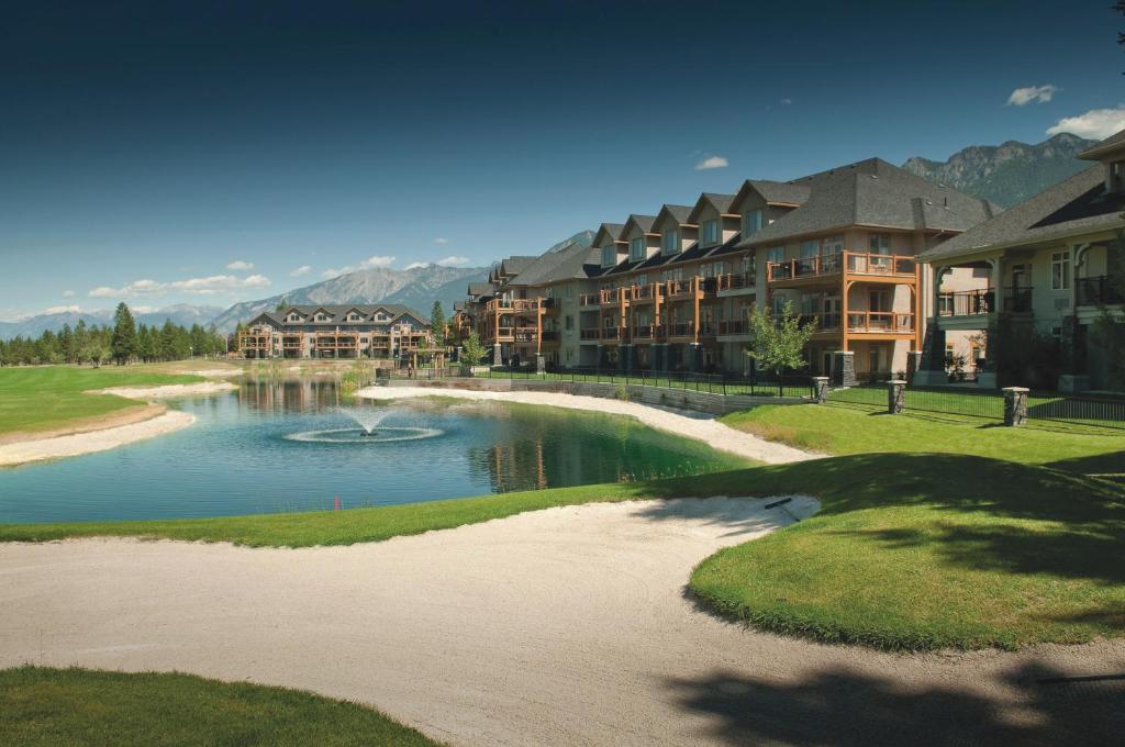a resort with a pond in the middle of a resort at Bighorn Meadows Resort in Radium Hot Springs