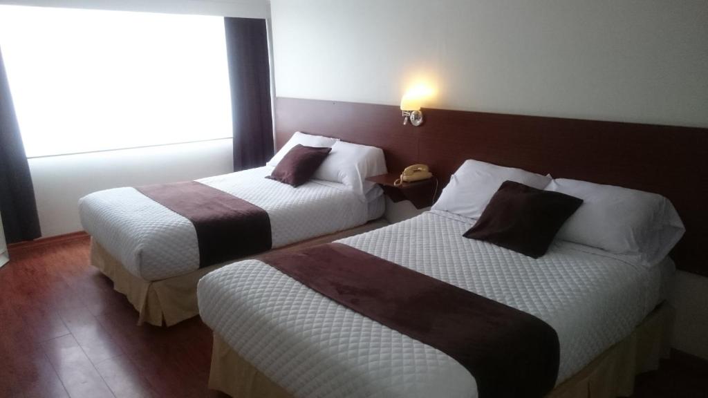 Postel nebo postele na pokoji v ubytování Gran Hotel Napoleón