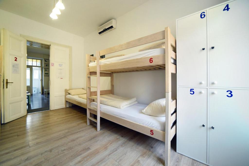 a room with two bunk beds and a hallway at Hostel Temza in Zagreb