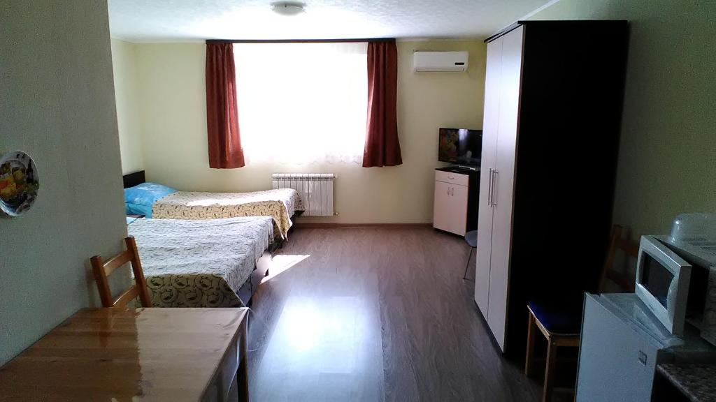 a small room with two beds and a window at Guest House on Festivalnaya in Dagomys