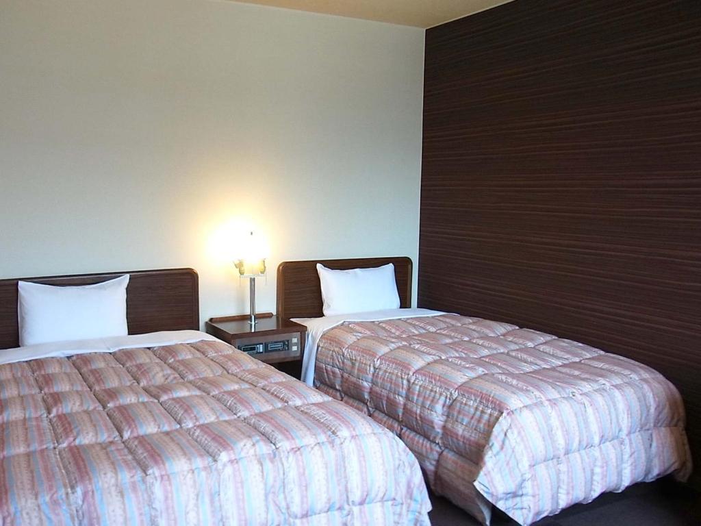 Postel nebo postele na pokoji v ubytování Hotel Tamanoya