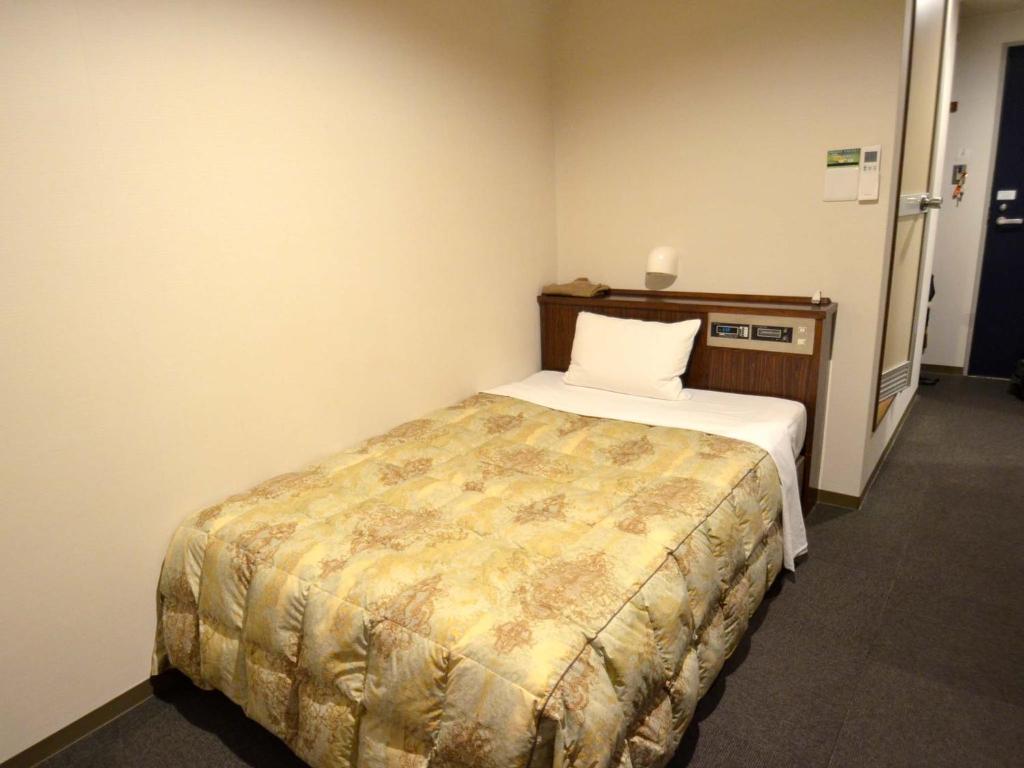 Postel nebo postele na pokoji v ubytování Hotel Tamanoya