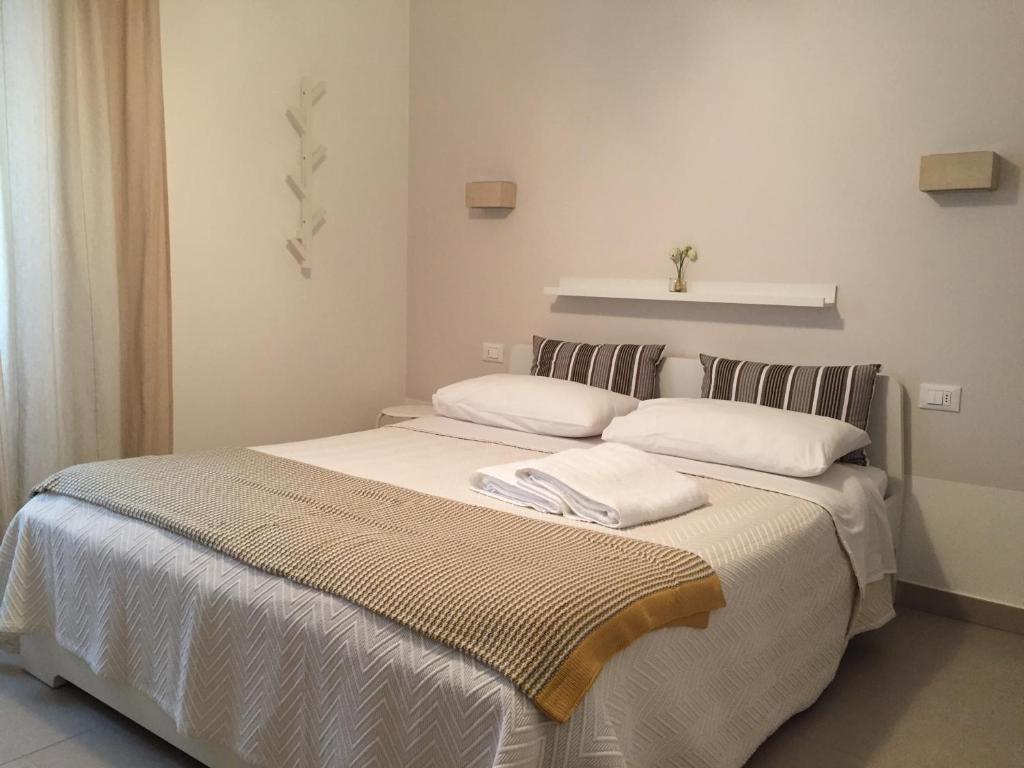 a bedroom with a bed with two pillows on it at SulMare Alba Adriatica in Alba Adriatica