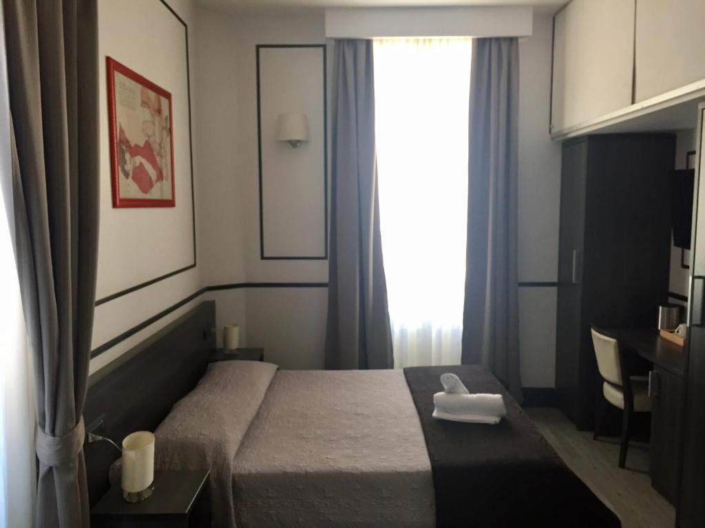 a hotel room with a bed and a window at Royal Suite du Vatican in Rome