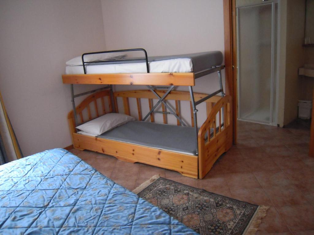 two bunk beds in a room with a bed at Hotel Vittoria in Riva del Garda