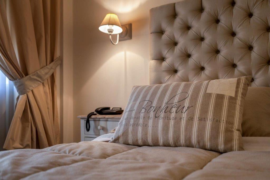 a bedroom with a bed with a headboard and a lamp at Viva Hotel Avellino in Avellino