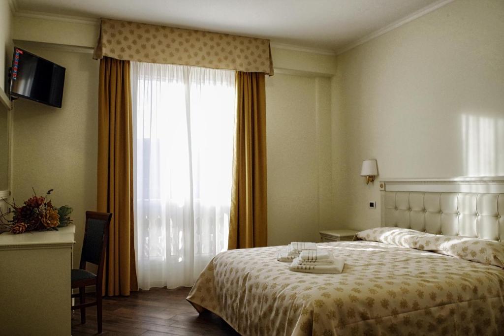 Postel nebo postele na pokoji v ubytování Hotel Colaiaco