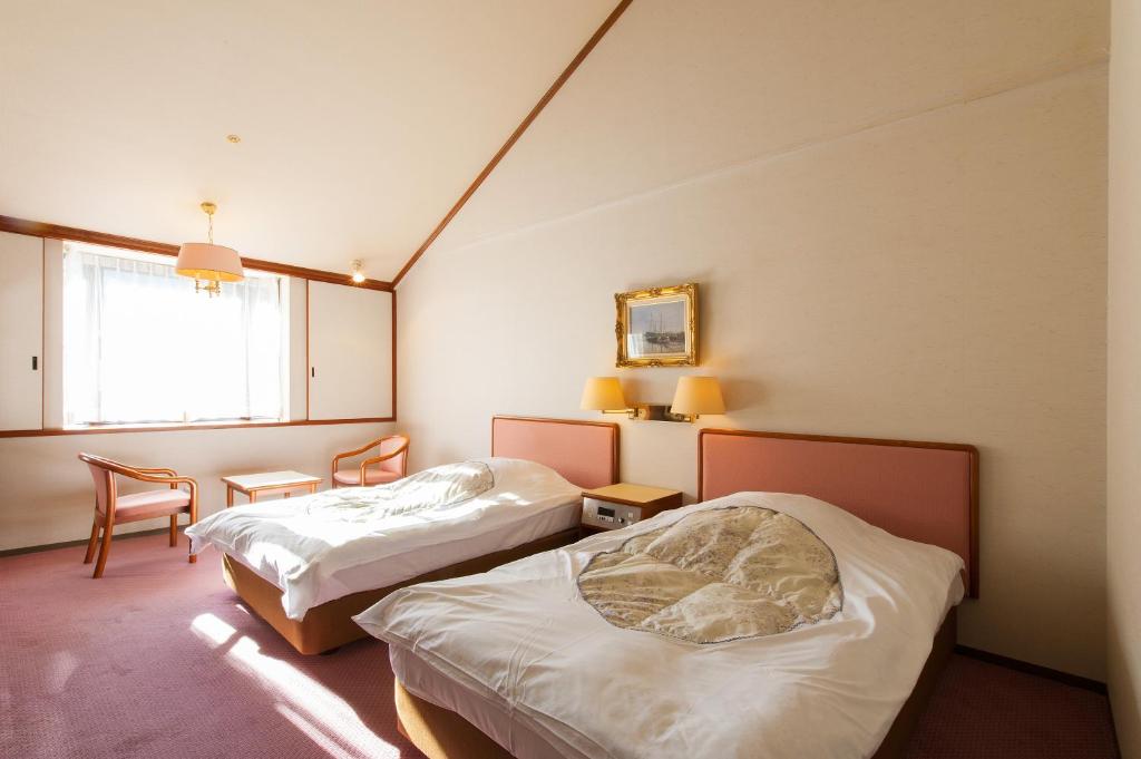 Postel nebo postele na pokoji v ubytování Watarase Onsen Hotel Sasayuri