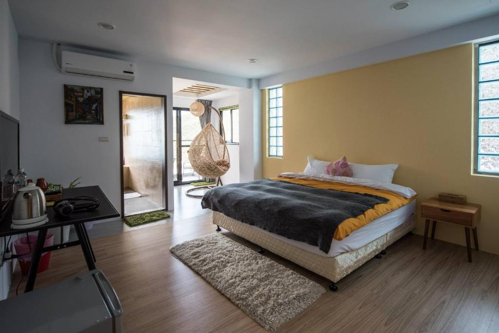 a bedroom with a bed and a desk and a mirror at Arabian Nights in Jiufen in Jiufen