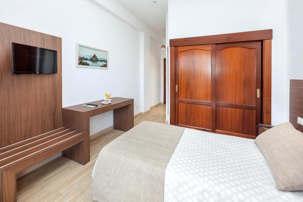 Postel nebo postele na pokoji v ubytování Hotel Don Manolito