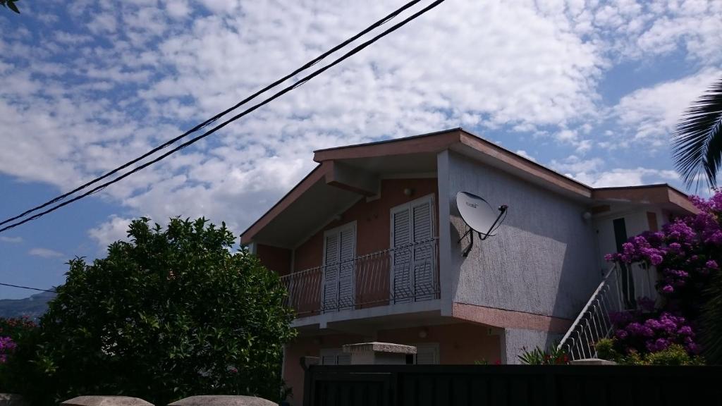 a house with a satellite on the side of it at Adria MN Apartment in Utjeha