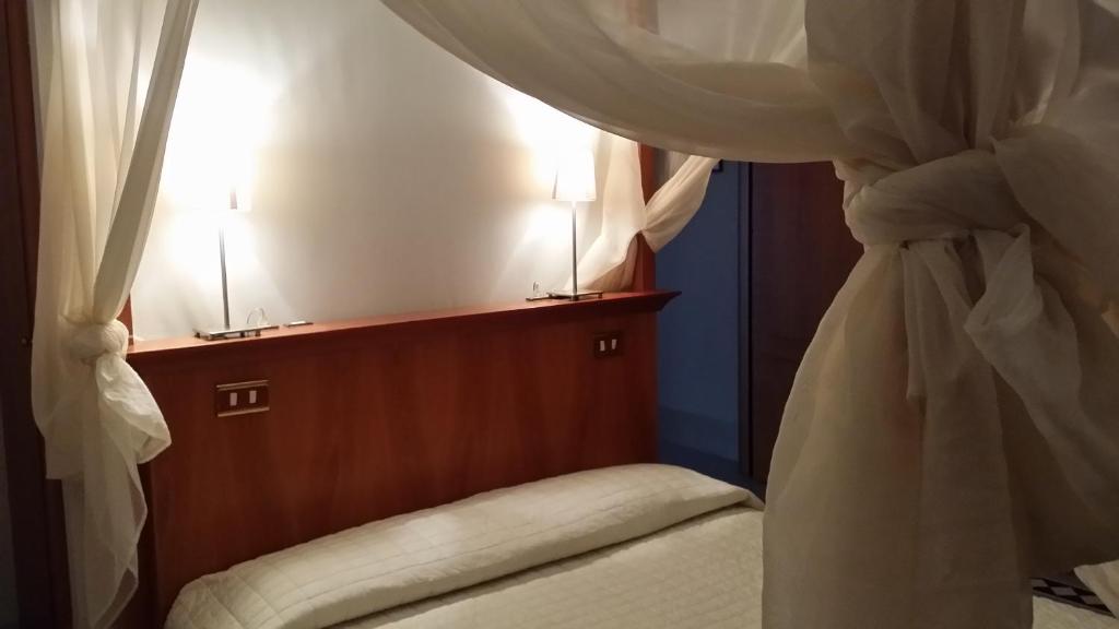 Postel nebo postele na pokoji v ubytování Modà Antica Dimora