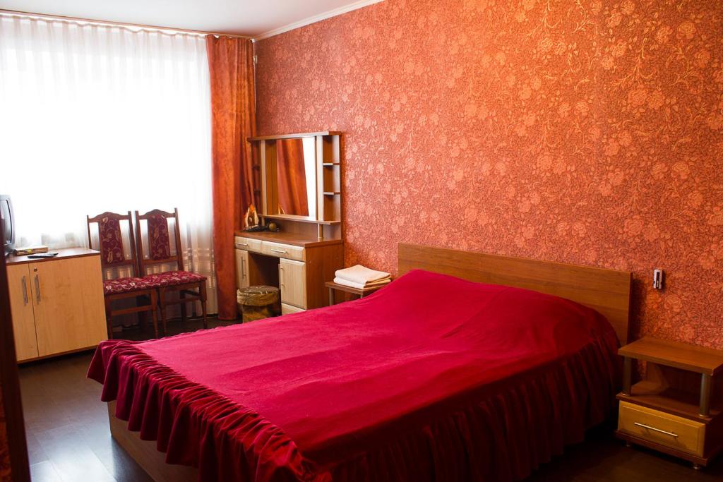 ヴィーンヌィツャにあるApartments near centerの赤いベッド1台(赤い毛布付)が備わるベッドルーム1室が備わります。