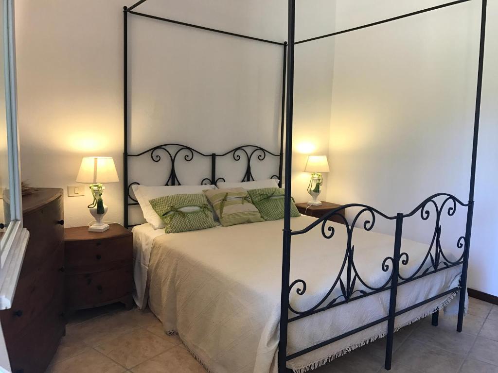 a bedroom with a black and white canopy bed at Sa Tirìa in Chia