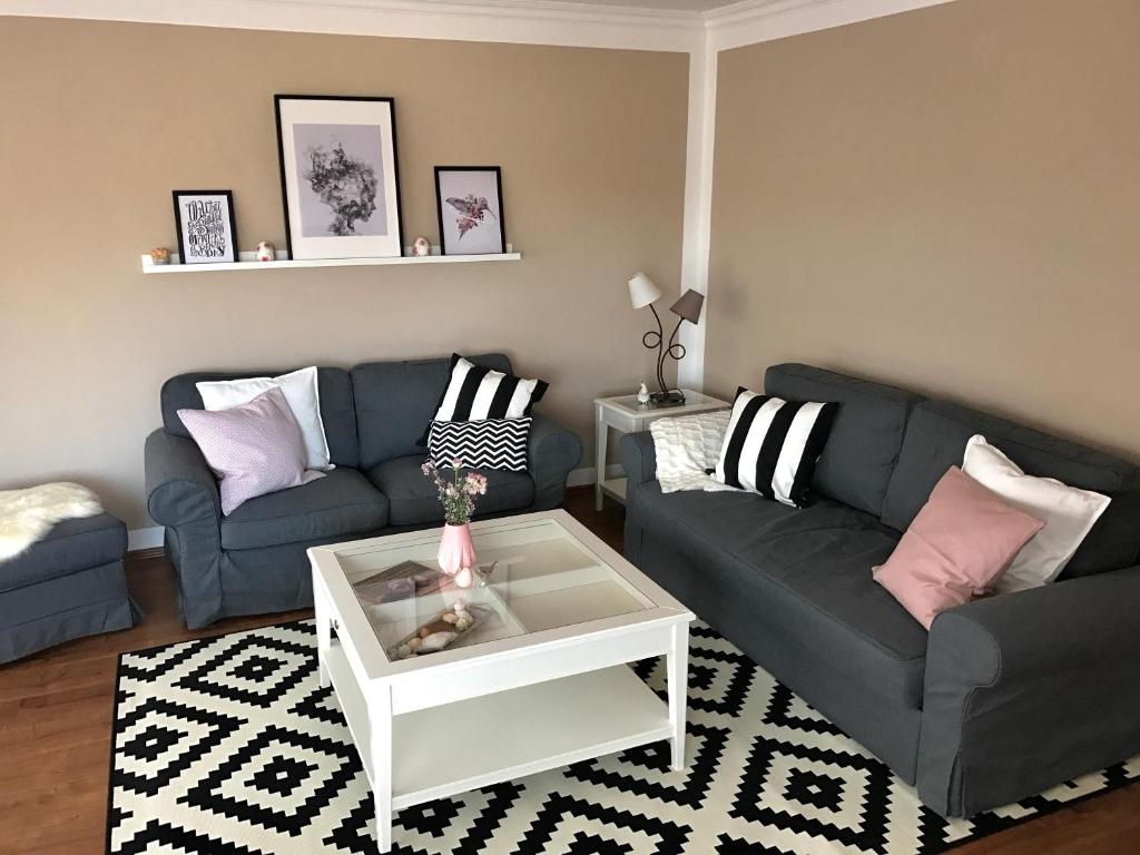 a living room with two couches and a coffee table at Apartment Happy Mosel in Cochem