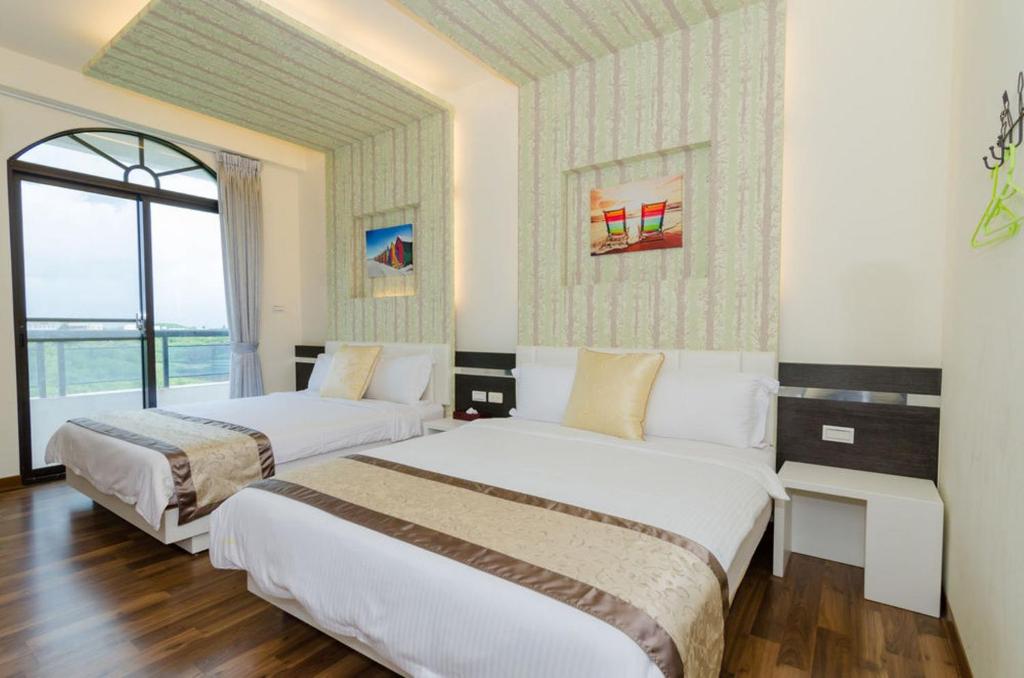 Postel nebo postele na pokoji v ubytování 海漣天海岸民宿 & 水連天海景電梯民宿 Sea Sky Coast Homestay & Shui-lian-tian Homestay