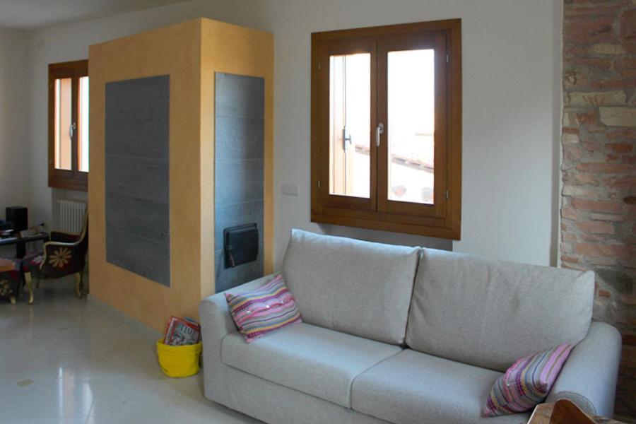 a living room with a couch and a window at Antica Corte Leguzzano B&B in San Vito di Leguzzano