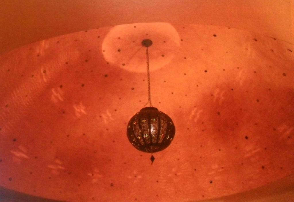a chandelier hanging from the ceiling of a room at Case d'Artista in Savelletri di Fasano