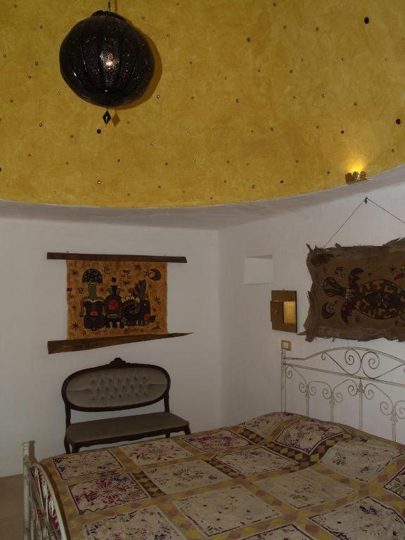 a bedroom with a bed and a ceiling at Case d'Artista in Savelletri di Fasano
