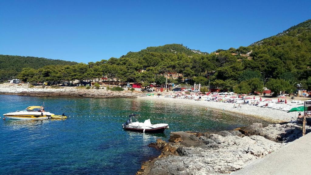 two boats in the water next to a beach at Apartment Mia in Hvar