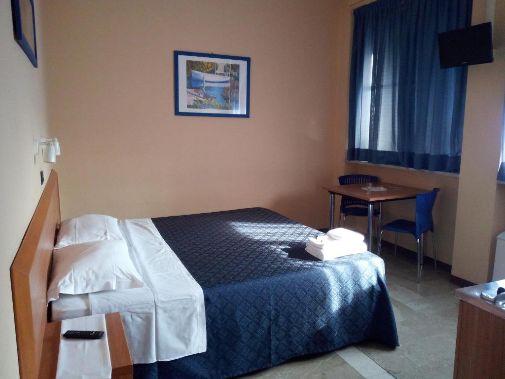 a hotel room with a bed and a table and a window at Hotel Residence Degra in Salassa
