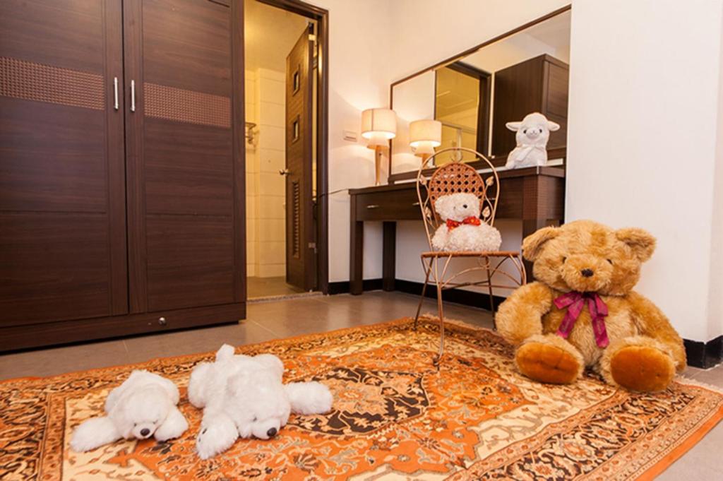 a group of stuffed animals sitting on a rug in a room at Rice Countryside in Dongshan