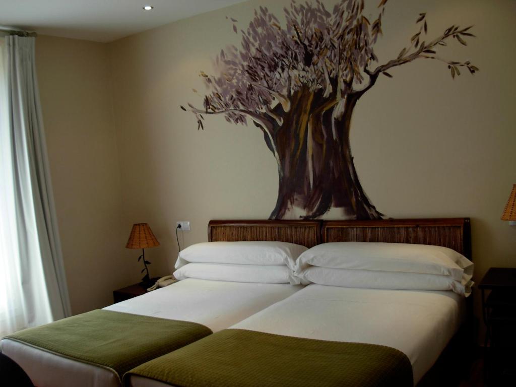 Postel nebo postele na pokoji v ubytování Hotel el Jardín de Eugenia