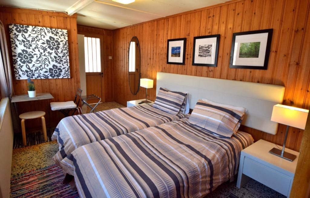 a bedroom with a bed in a room with wooden walls at Christys Palace Hotel in Pedoulas