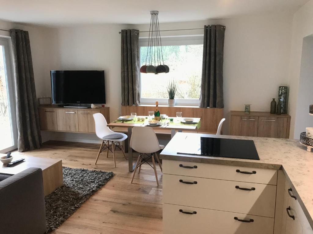 a kitchen and living room with a table and chairs at Ferienwohnung Sailer in Bruck an der Mur