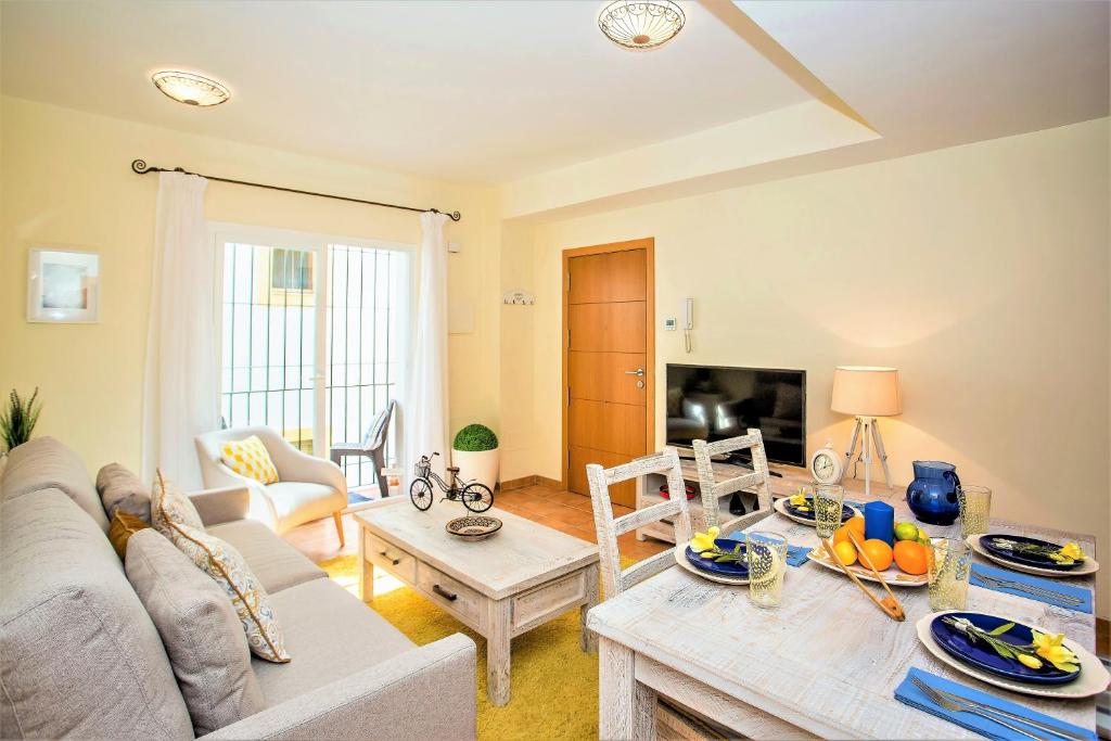 a living room with a couch and a table at The Old Town Apartment in Marbella