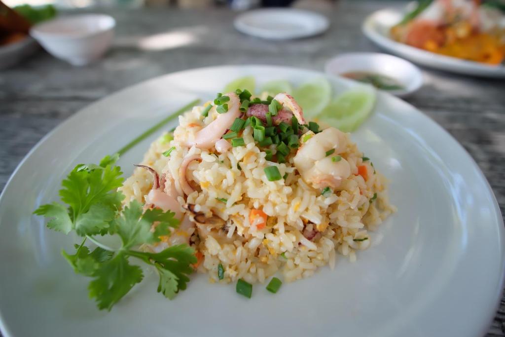 a plate of food with shrimp and rice on a table at Vimarn Samed Resort in Ko Samed
