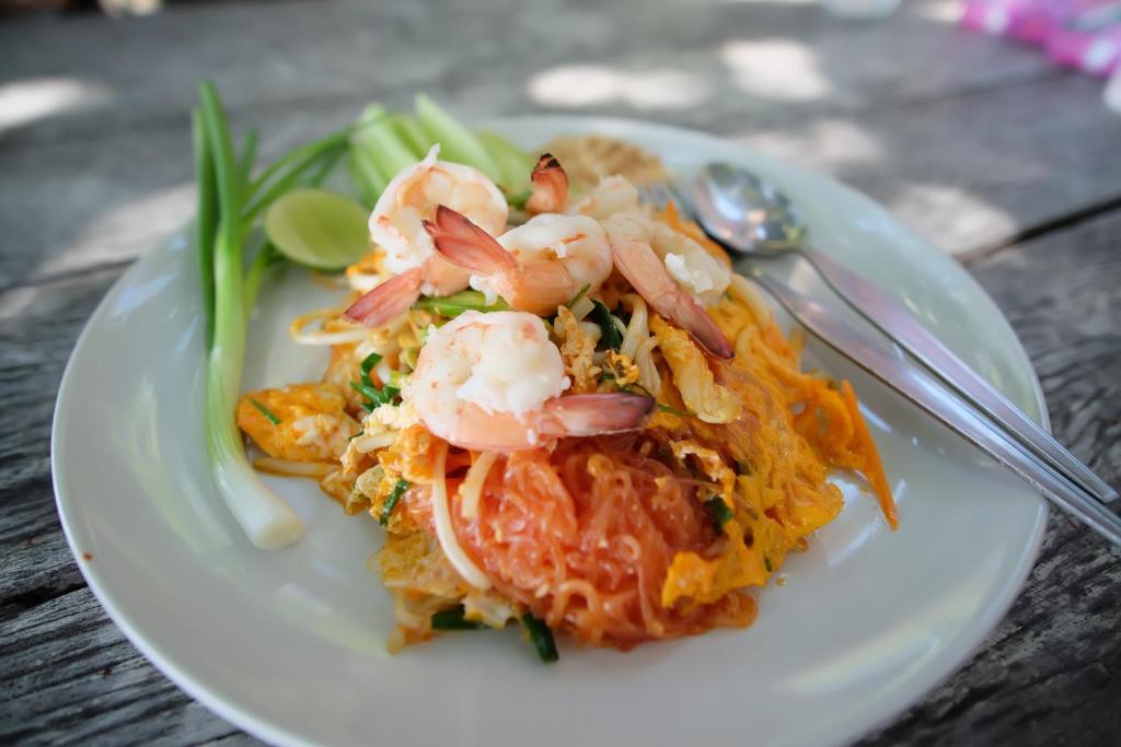 a plate of food with shrimp and vegetables on a table at Vimarn Samed Resort in Ko Samed