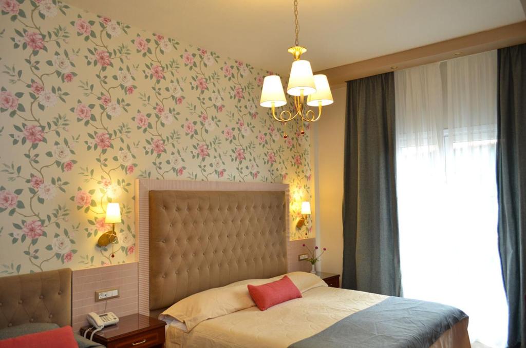 Postel nebo postele na pokoji v ubytování Olympic Hotel